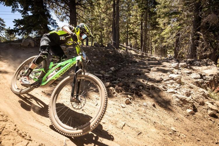 A photo of a bike racer going down a hill during the Monster Energy Pro Downhill event at Big Bear Mountain Resort.