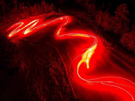 A stream of flaming torches lights a ski run during a New Year's parade in Big Bear, CA. Long exposure shot.
