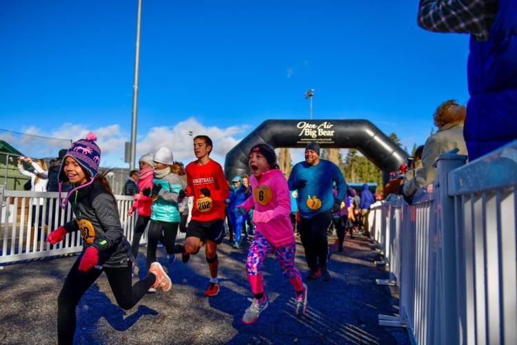The starting line of the Thanksgiving Turkey Trot, racers both male and female of all ages are beginning their trot.