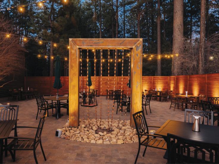 Patio seating at Captain's Anchorage is lit in the evening with beautiful accent lighting.